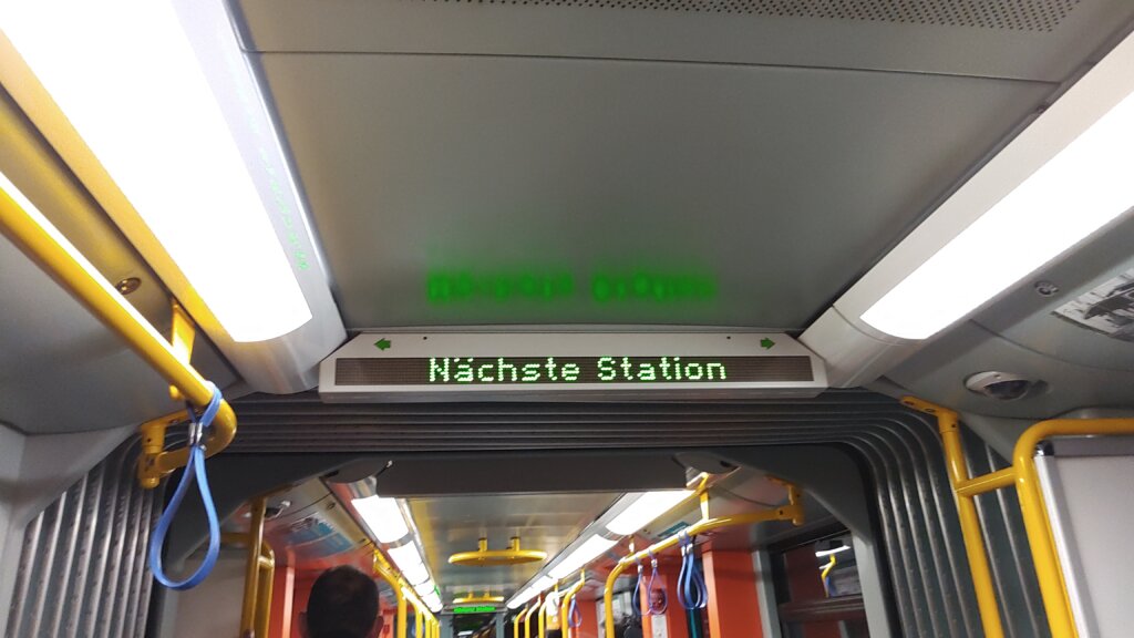 Digital signage in a underground carriage displaying: Nächste Station